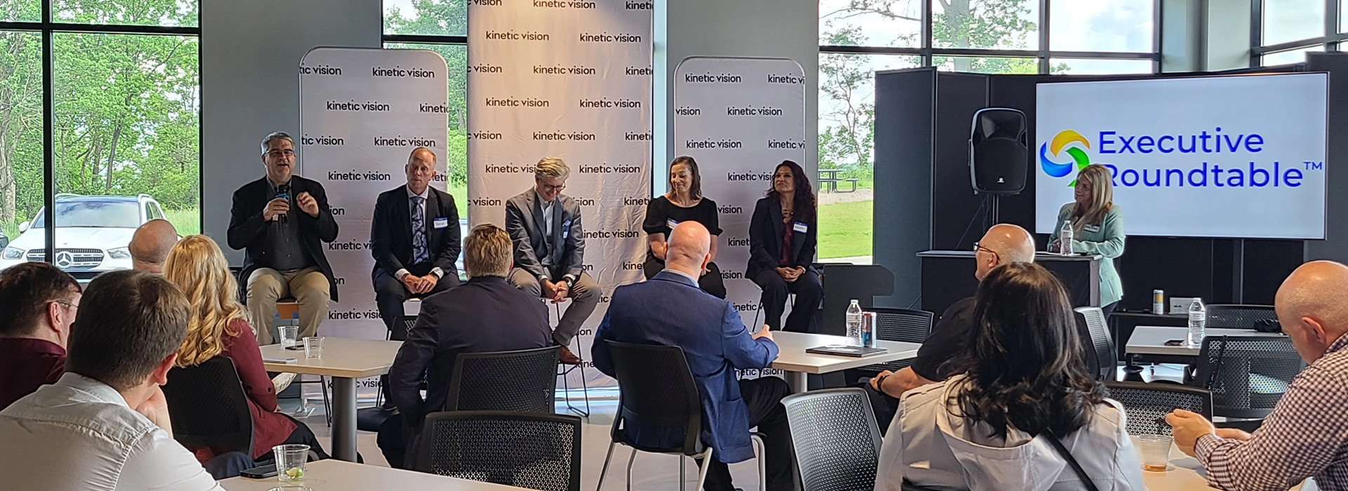 A photo of an expert panel on stage discussing Digital Transformation.