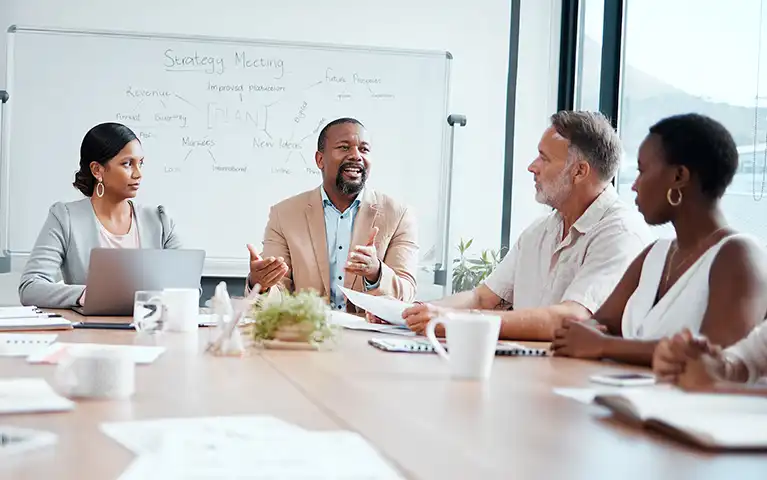 A photo of business people meeting about change management within their organization.