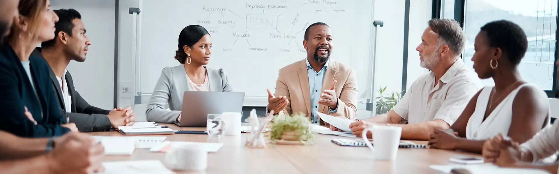 Smiling group of diverse businesspeople discussing business transformation consulting.